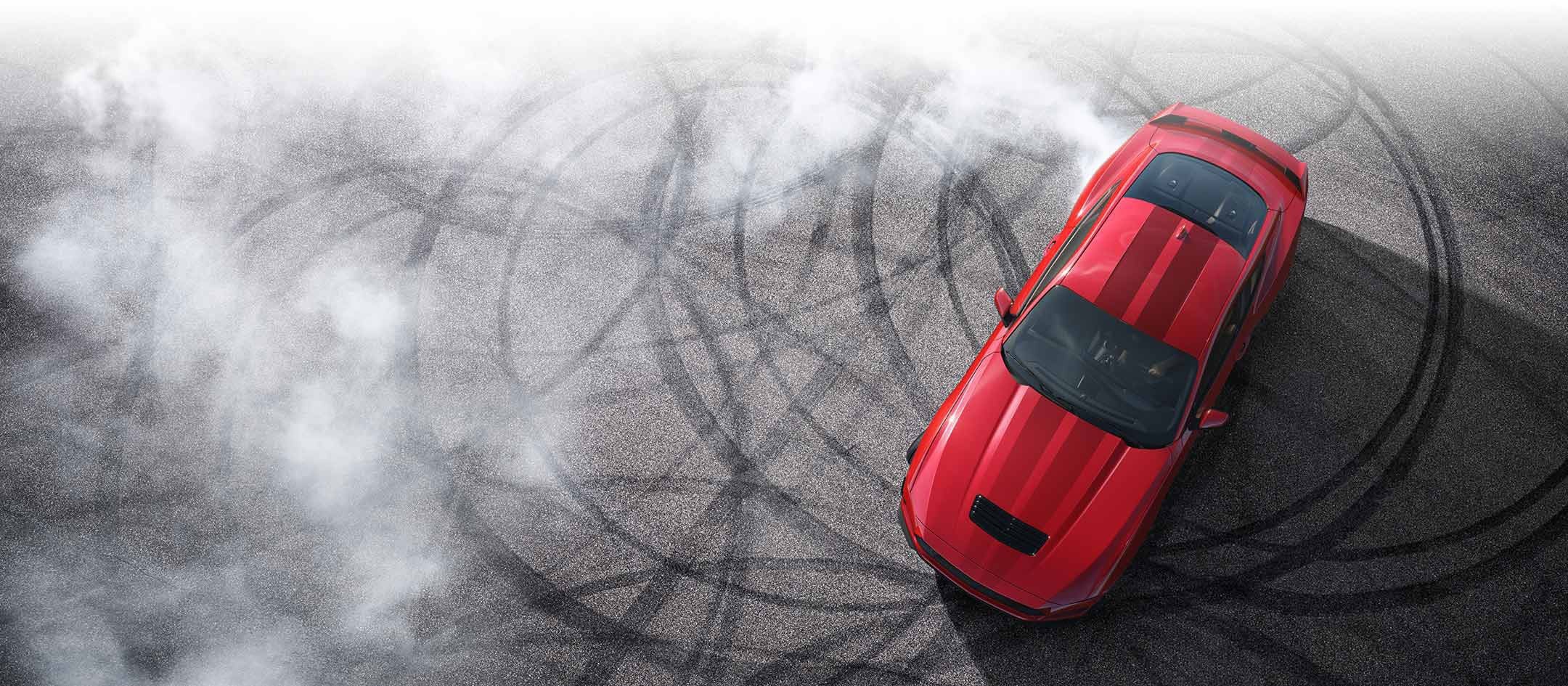 Overhead view of a 2024 Ford Mustang® model with tire tracks on pavement | Bergstrom Ford of Neenah in Neenah WI
