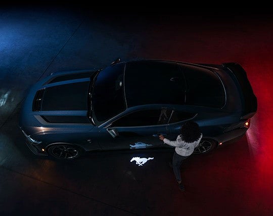 2024 Ford Mustang® Dark Horse™ model with a driver approaching the vehicle | Bergstrom Ford of Neenah in Neenah WI